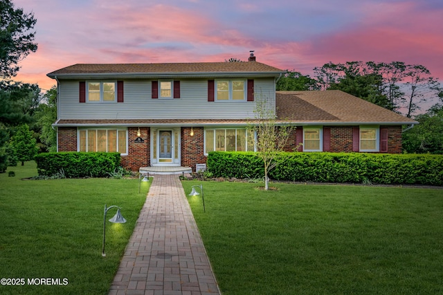 36 Stoney Creek Ln, Colts Neck, NJ 07722 - view of front of property with a chimney, a front yard, brick siding, and roof with shingles