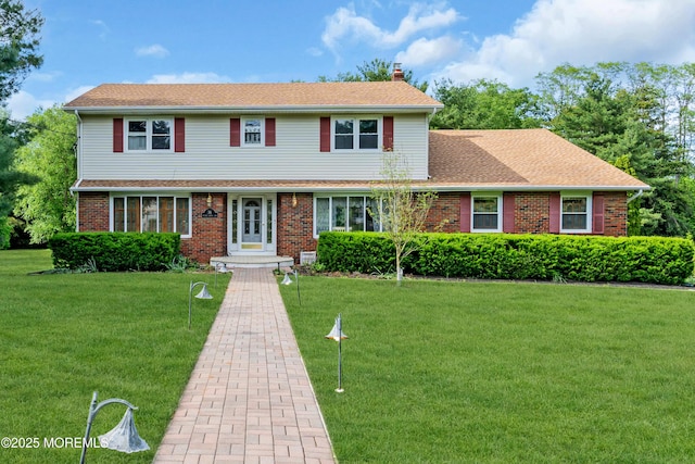36 Stoney Creek Ln, Colts Neck, NJ 07722 - view of front of property featuring a chimney, a front lawn, brick siding, and a shingled roof
