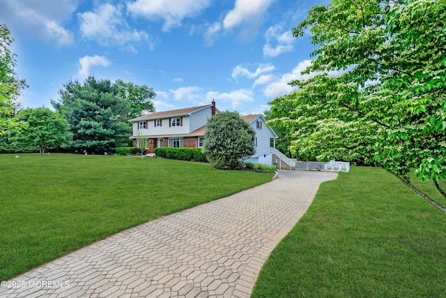 36 Stoney Creek Ln, Colts Neck, NJ 07722 - view of front of home with a front yard, decorative driveway, and brick siding