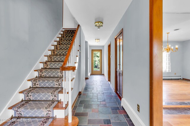 36 Stoney Creek Ln, Colts Neck, NJ 07722 - staircase featuring a baseboard radiator, baseboards, a chandelier, and stone tile flooring