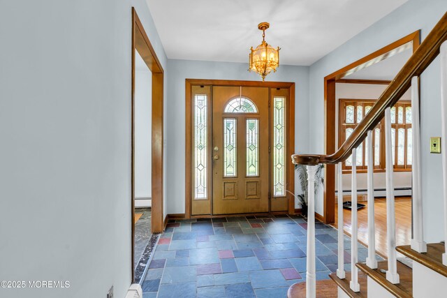36 Stoney Creek Ln, Colts Neck, NJ 07722 - foyer entrance featuring stone tile flooring, baseboards, healthy amount of natural light, and a chandelier