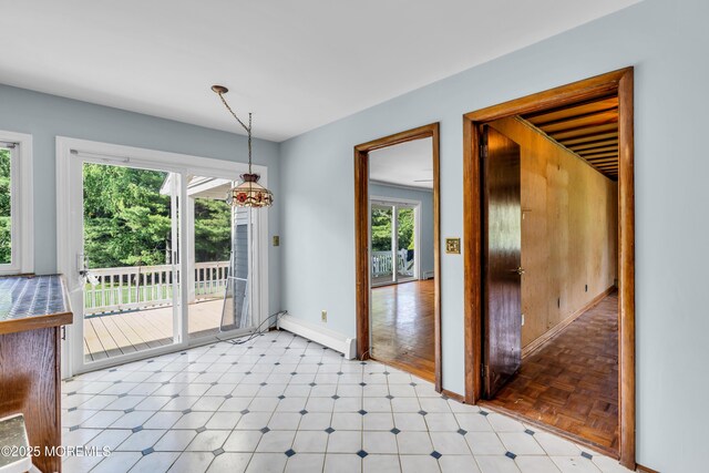 36 Stoney Creek Ln, Colts Neck, NJ 07722 - unfurnished dining area with a baseboard heating unit, baseboards, and light floors