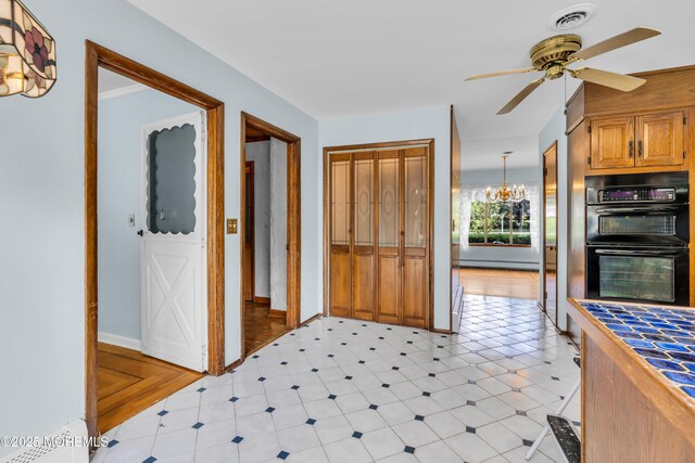 36 Stoney Creek Ln, Colts Neck, NJ 07722 - kitchen with ceiling fan, a baseboard heating unit, tile counters, a chandelier, and baseboards