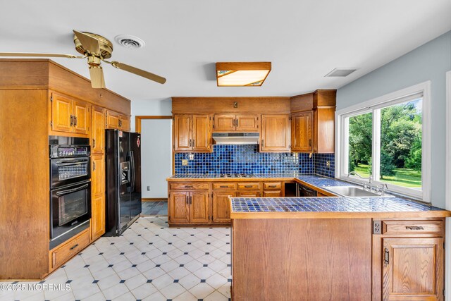 36 Stoney Creek Ln, Colts Neck, NJ 07722 - kitchen with black appliances, under cabinet range hood, a peninsula, a sink, and light floors