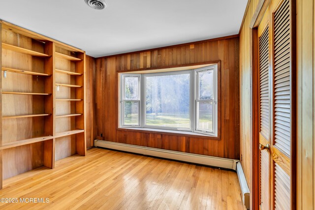 36 Stoney Creek Ln, Colts Neck, NJ 07722 - interior space featuring light wood finished floors, a baseboard heating unit, and wood walls