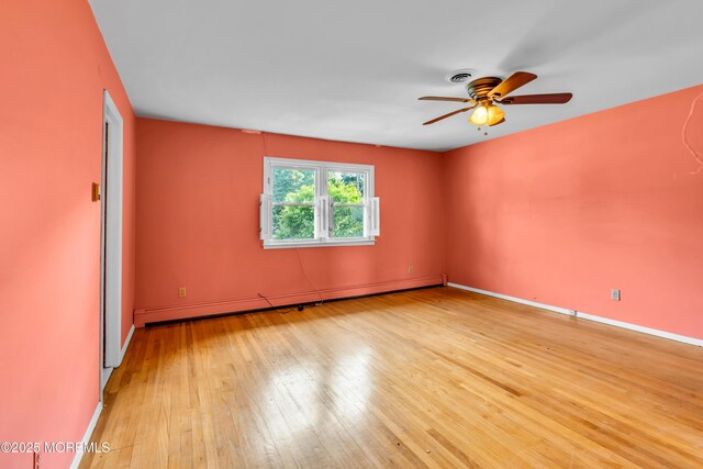 36 Stoney Creek Ln, Colts Neck, NJ 07722 - empty room with a baseboard radiator, ceiling fan, hardwood / wood-style floors, and baseboards