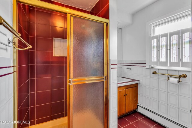 36 Stoney Creek Ln, Colts Neck, NJ 07722 - full bath featuring a baseboard heating unit, a stall shower, tile walls, tile patterned flooring, and vanity