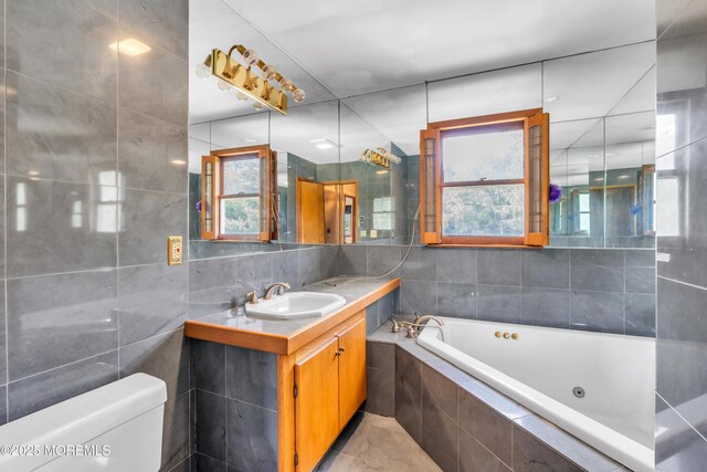36 Stoney Creek Ln, Colts Neck, NJ 07722 - bathroom featuring tile walls, a whirlpool tub, vanity, toilet, and plenty of natural light
