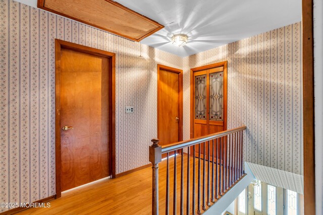 36 Stoney Creek Ln, Colts Neck, NJ 07722 - hall with an upstairs landing, light wood finished floors, and wallpapered walls