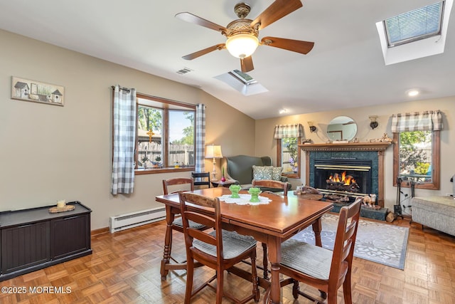 7 Monterey Dr, Hazlet, NJ 07730 - dining room with a baseboard radiator, a skylight, a ceiling fan, a glass covered fireplace, and baseboards