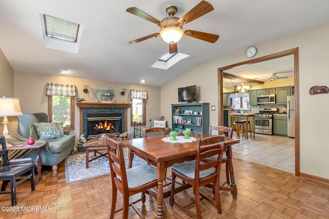 7 Monterey Dr, Hazlet, NJ 07730 - dining room featuring a skylight, a premium fireplace, a ceiling fan, and lofted ceiling