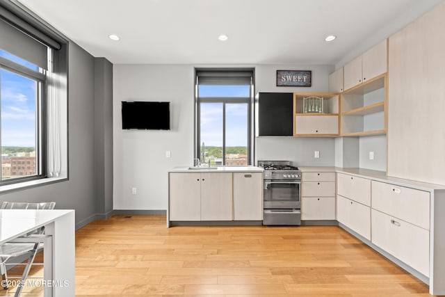 601 Bangs Ave Unit 701, Asbury Park, NJ 07712 - kitchen featuring stainless steel gas range oven, light countertops, light wood-style floors, recessed lighting, and a sink