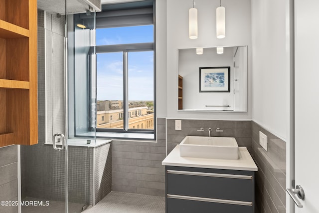 601 Bangs Ave Unit 701, Asbury Park, NJ 07712 - full bathroom with vanity, tile walls, a stall shower, and a wainscoted wall