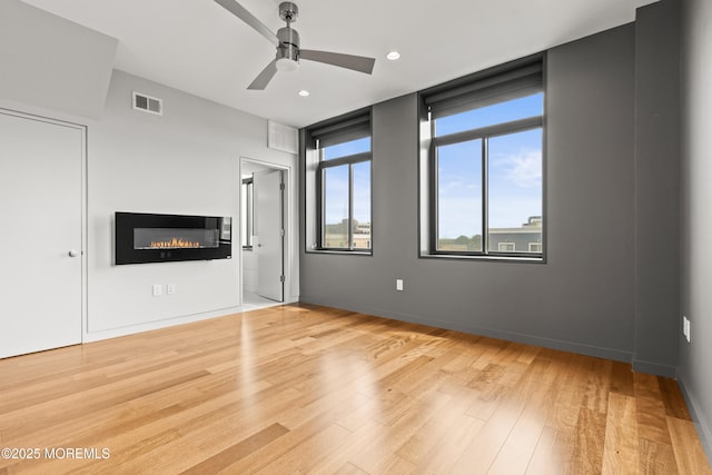 601 Bangs Ave Unit 701, Asbury Park, NJ 07712 - unfurnished living room featuring a ceiling fan, wood finished floors, a glass covered fireplace, and recessed lighting