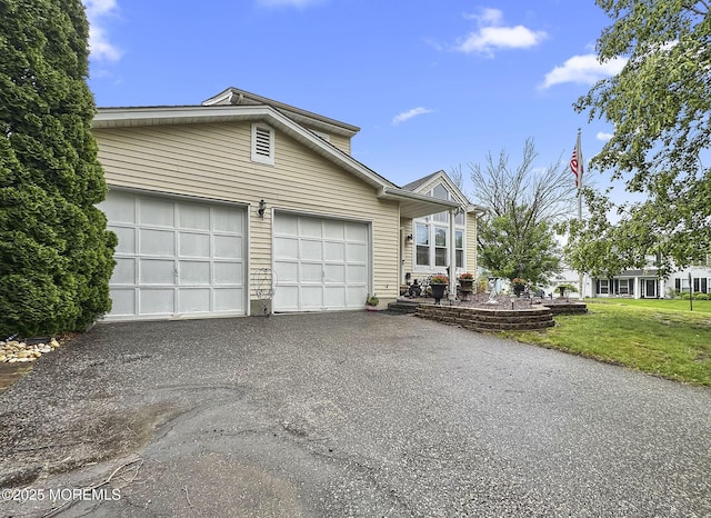 9 Sami Dr, Howell, NJ 07731 - view of front facade featuring asphalt driveway, an attached garage, and a front lawn
