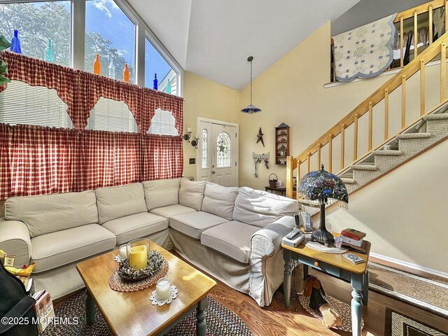 9 Sami Dr, Howell, NJ 07731 - living room with high vaulted ceiling, stairs, and wood finished floors