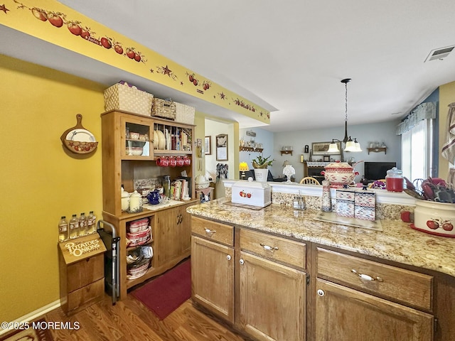9 Sami Dr, Howell, NJ 07731 - kitchen featuring wood finished floors, hanging light fixtures, open floor plan, and light stone countertops