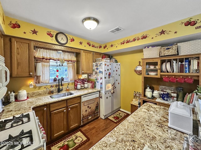 9 Sami Dr, Howell, NJ 07731 - kitchen featuring white appliances, brown cabinetry, wood finished floors, light stone counters, and open shelves