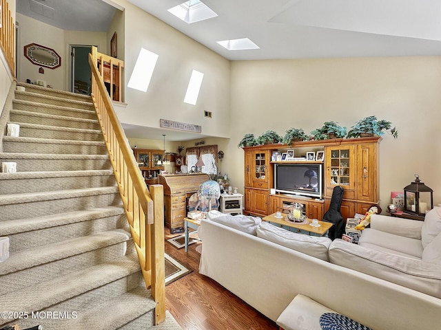 9 Sami Dr, Howell, NJ 07731 - living room with wood finished floors, a skylight, stairway, and a high ceiling