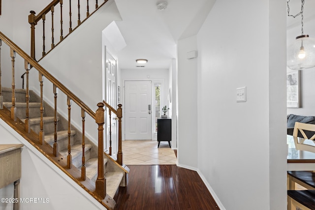 405 Hampton Ct Unit 15-4, Manalapan, NJ 07726 - foyer entrance with baseboards, wood finished floors, and stairs