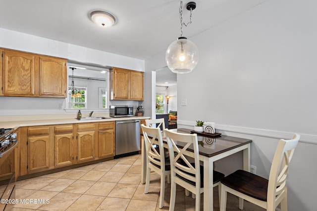 405 Hampton Ct Unit 15-4, Manalapan, NJ 07726 - kitchen with stainless steel appliances, a sink, light tile patterned floors, light countertops, and pendant lighting