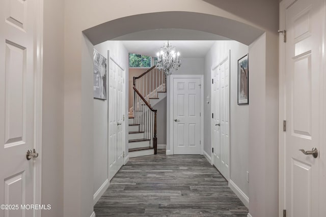 6 Bordens Brook Way, Holmdel, NJ 07733 - corridor with arched walkways, a chandelier, dark wood-style flooring, and baseboards