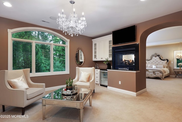 6 Bordens Brook Way, Holmdel, NJ 07733 - living area featuring a chandelier, light colored carpet, arched walkways, and baseboards