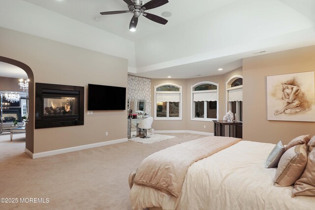 6 Bordens Brook Way, Holmdel, NJ 07733 - bedroom with light carpet, a multi sided fireplace, baseboards, recessed lighting, and arched walkways