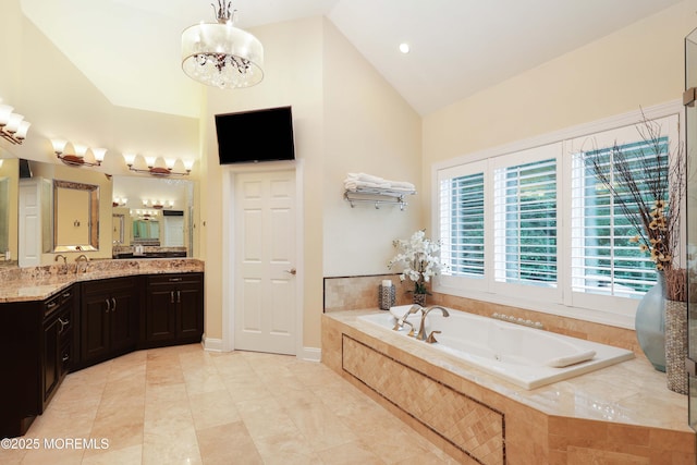 6 Bordens Brook Way, Holmdel, NJ 07733 - bathroom with high vaulted ceiling, vanity, a garden tub, and a chandelier