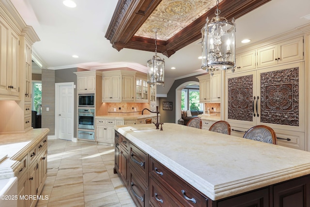 6 Bordens Brook Way, Holmdel, NJ 07733 - kitchen featuring cream cabinets, oven, built in microwave, a warming drawer, and ornamental molding