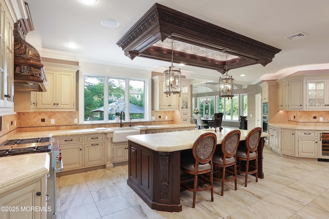 6 Bordens Brook Way, Holmdel, NJ 07733 - kitchen featuring cream cabinetry, light countertops, wine cooler, stainless steel appliances, and a center island