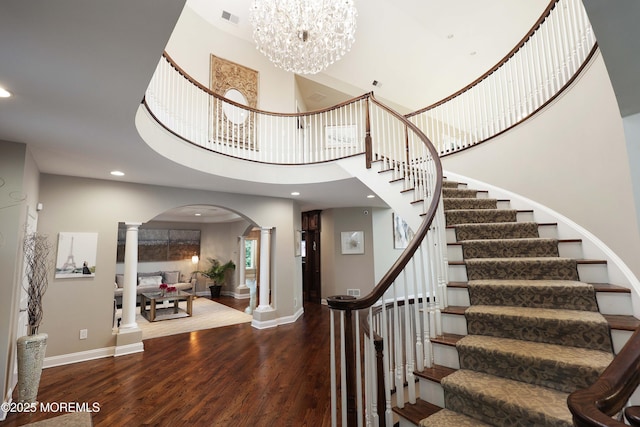 6 Bordens Brook Way, Holmdel, NJ 07733 - staircase with ornate columns, arched walkways, wood finished floors, a chandelier, and recessed lighting