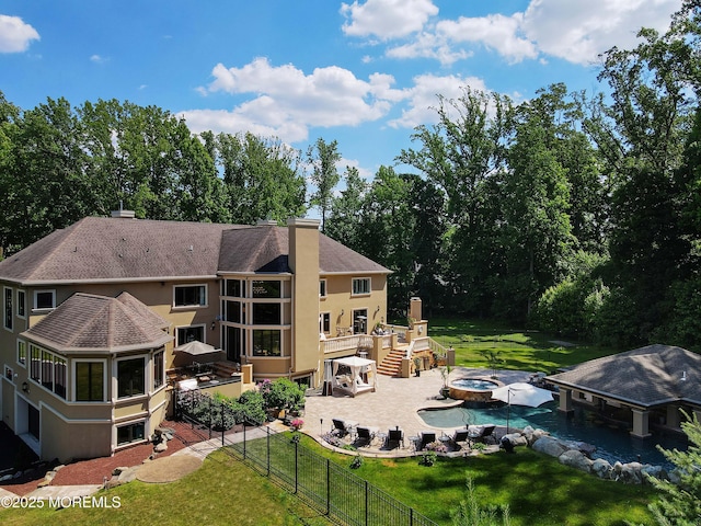 6 Bordens Brook Way, Holmdel, NJ 07733 - rear view of house featuring an in-ground hot tub, a patio area, stucco siding, and a deck