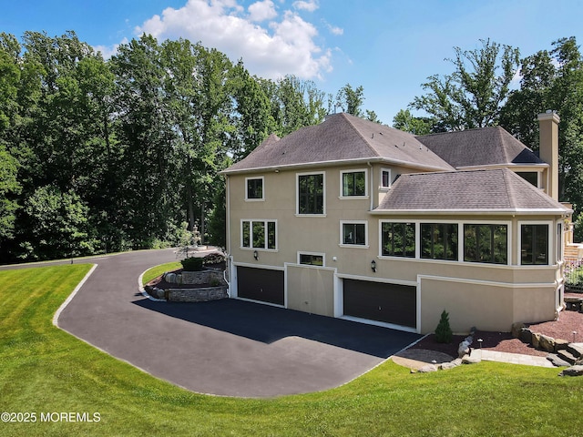 6 Bordens Brook Way, Holmdel, NJ 07733 - back of house with a garage, asphalt driveway, a chimney, and stucco siding