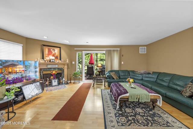 33 Oliver Ct Unit 1, Freehold, NJ 07728 - living room with light wood-style floors and a fireplace with flush hearth