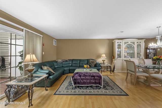 33 Oliver Ct Unit 1, Freehold, NJ 07728 - living room featuring a chandelier and wood finished floors
