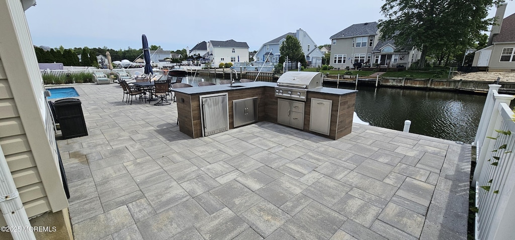 29 Longpoint Dr, Brick, NJ 08723 - view of patio featuring a water view, a residential view, a sink, and outdoor dining space