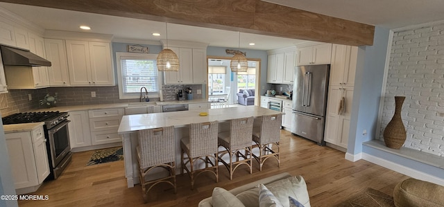 29 Longpoint Dr, Brick, NJ 08723 - kitchen featuring appliances with stainless steel finishes, under cabinet range hood, a breakfast bar, white cabinets, and recessed lighting