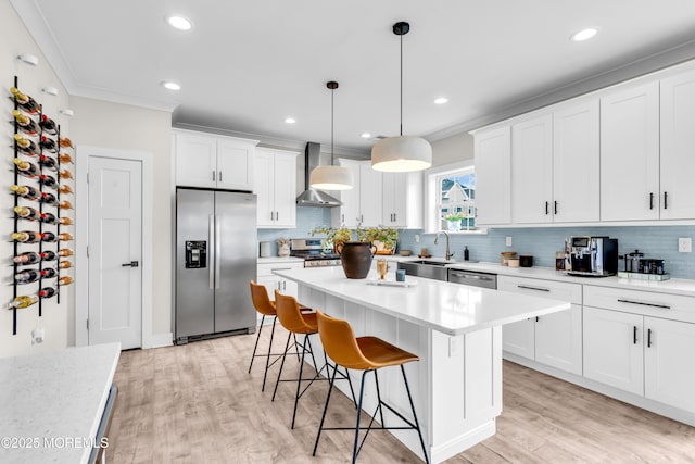 6 Harpoon Dr, Barnegat, NJ 08005 - kitchen with stainless steel appliances, wall chimney exhaust hood, a breakfast bar area, a sink, and backsplash