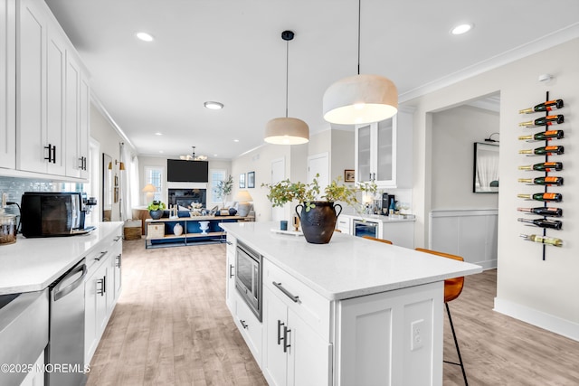 6 Harpoon Dr, Barnegat, NJ 08005 - kitchen with appliances with stainless steel finishes, a breakfast bar area, light wood finished floors, white cabinetry, and light countertops