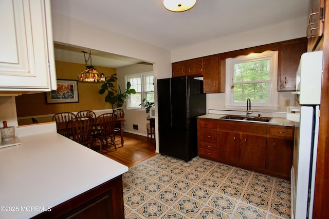 208 Hillcrest Ave, Neptune Township, NJ 07753 - kitchen with freestanding refrigerator, a sink, and healthy amount of natural light