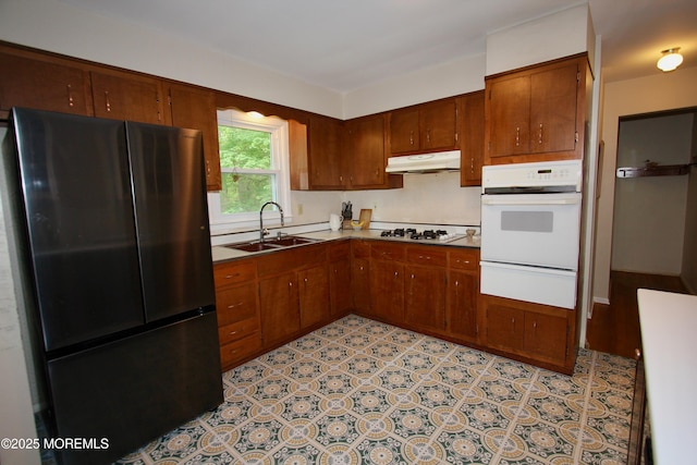 208 Hillcrest Ave, Neptune Township, NJ 07753 - kitchen featuring white appliances, a warming drawer, a sink, under cabinet range hood, and brown cabinets