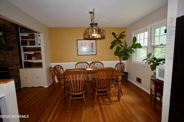 208 Hillcrest Ave, Neptune Township, NJ 07753 - dining space with wood finished floors, baseboards, and built in shelves