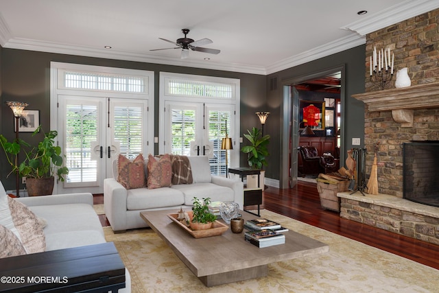 7 Stoney Brook Dr, Millstone, NJ 08510 - living area featuring french doors, wood finished floors, a large fireplace, crown molding, and a ceiling fan