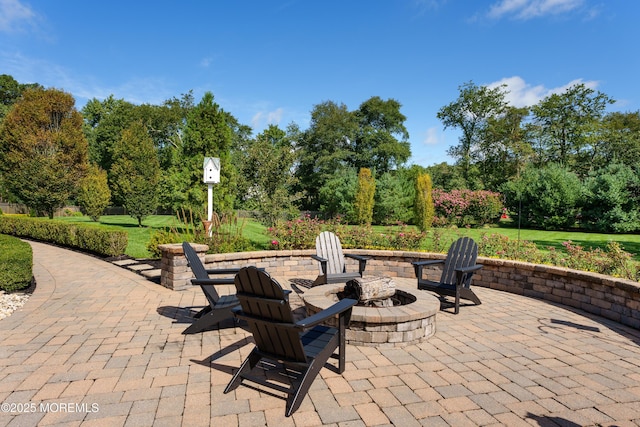 7 Stoney Brook Dr, Millstone, NJ 08510 - view of patio with an outdoor fire pit and view of wooded area