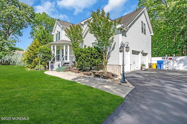 9 Kindling Way, Jackson, NJ 08527 - view of front facade with asphalt driveway, a garage, a front lawn, a porch, and a gate
