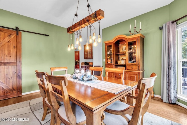 9 Kindling Way, Jackson, NJ 08527 - dining space featuring light wood finished floors, a barn door, and baseboards