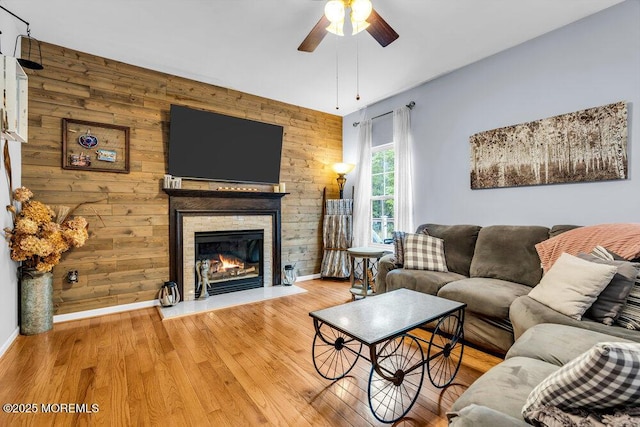 9 Kindling Way, Jackson, NJ 08527 - living room with ceiling fan, baseboards, a stone fireplace, wood finished floors, and wooden walls