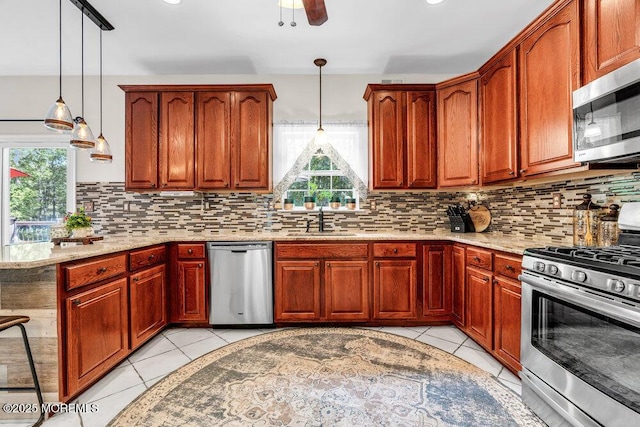 9 Kindling Way, Jackson, NJ 08527 - kitchen featuring stainless steel appliances, a sink, decorative backsplash, and light stone counters