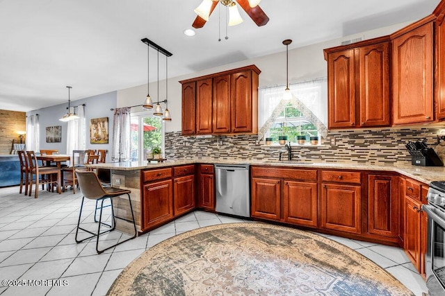 9 Kindling Way, Jackson, NJ 08527 - kitchen featuring stainless steel appliances, a sink, a ceiling fan, a peninsula, and decorative backsplash